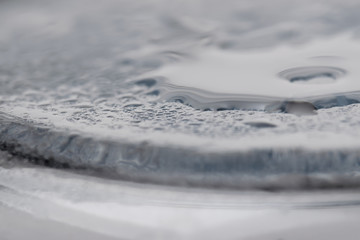 Water droplets close-up. Background of glass and water