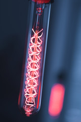 Fototapeta premium A classic Edison light bulb on dark background with space for text