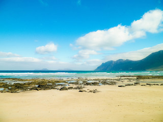 Fototapeta na wymiar Beach and mountains - beautiful coast in Caleta de Famara, Lanzarote Canary Islands.