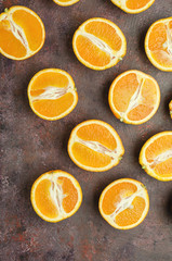 Halves of oranges on a dark.