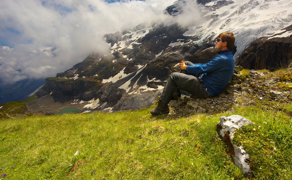 Resting tourist with a mountain landscape on bacground nearby resort of Kandersteg, Switzerland