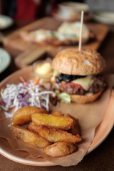 Fresh burger, potato slices and salad