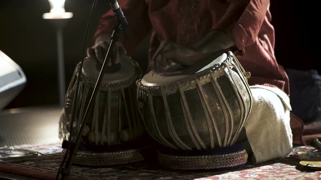 Man is playing on tabla