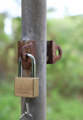 Closeup of a locked master key at outdoor entrance. Vertical view. 