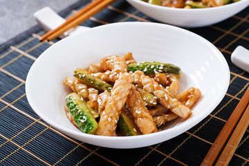 Thai spicy salad with squid and cucumber in sweet and sour sauce. Asian food.