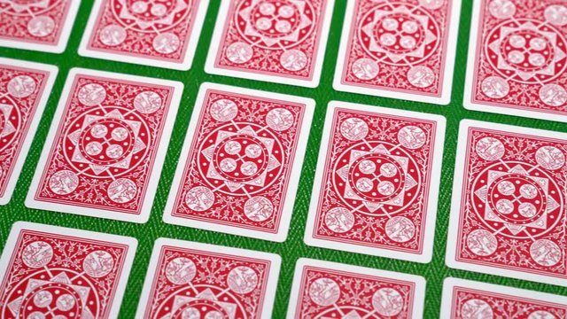 Smooth sliding shot of the card back of playing card flat lay on a poker table in 4K