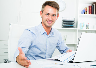 Business man sitting with document in office