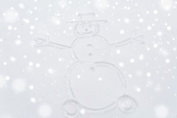 winter holidays and christmas concept - snowman drawing on snow surface