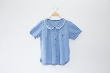 Mini scott colour blouse is clothes hanger on white background.