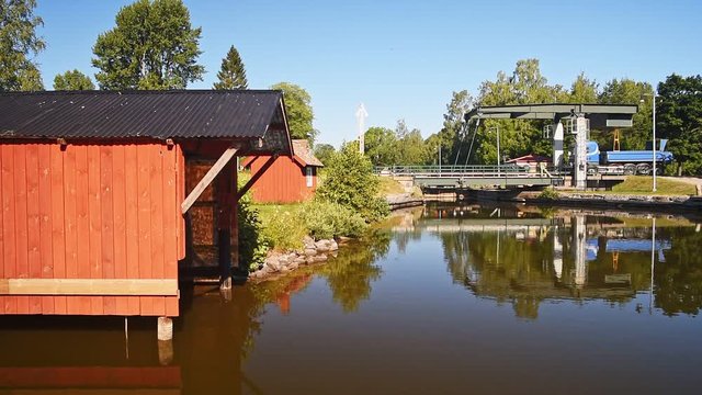 Blue truck passing over Gota canal on a small steel bascule bridge at Tatorp, Sweden.