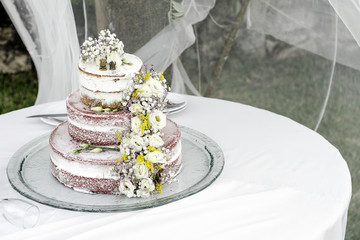 romantic rustic floral design wedding cake on table outdoors