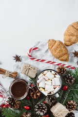 Fototapeta na wymiar Winter hot drink. Christmas hot chocolate or cocoa with marshmallow, cookies on white background with christmas decorations. Flat Lay.