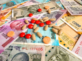 Pills over the 10, 20, 50, 100, 200, 500 and 2000 Indian rupees, old and new notes.