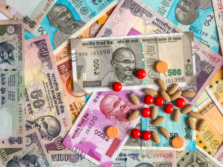 Pills over the 10, 20, 50, 100, 200, 500 and 2000 Indian rupees, old and new notes.