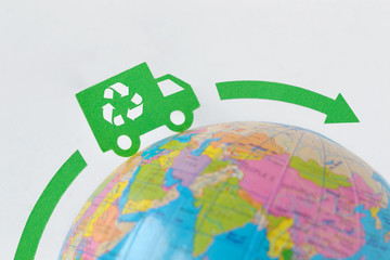 Green truck on earth globe - Ecological transport