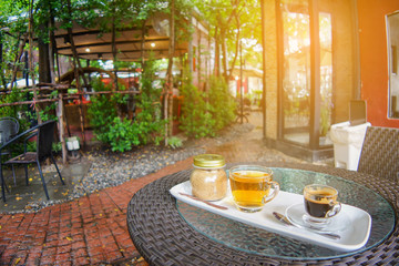 Coffee and tea cup with brown sugar jar on table 