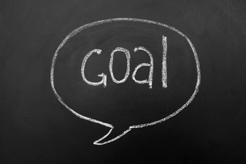 Speech bubble, Goal successful reaching concept on blackboard or chalkboard. Hand drawn inscription. 