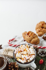 Winter hot drink. Christmas hot chocolate or cocoa with marshmallow, cookies   on white background with christmas decorations. Flat Lay.