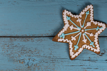 One Gingerbread Star on Wooden Background.Copy Space