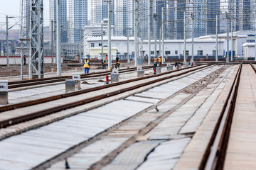 Fototapeta premium Railway workers maintain high-speed railway tracks at a high-speed railway station in kunming, southwest China's yunnan province, sept 28, 2018