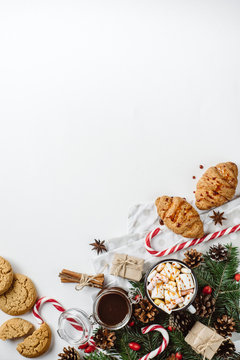 Winter hot drink. Christmas hot chocolate or cocoa with marshmallow, cookies   on white background with christmas decorations. Flat Lay.
