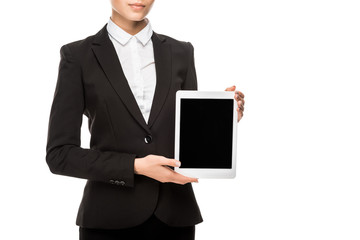 cropped shot of smiling young businesswoman holding tablet and looking at camera isolated on white