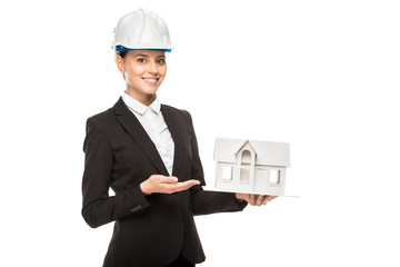cropped shot of smiling young female architect holding miniature house model isolated on white