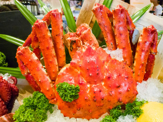Fresh, juicy and tasty poached whole Alaskan king crab or Taraba crab in their shell on ice bed. Sweet and flavorful. Contain cholesterol, but low in saturated fat and also have omega-3 fatty acid.