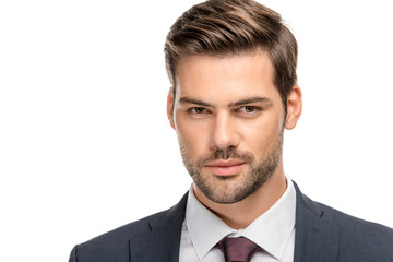 close-up portrait of handsome young businessman in jacket looking at camera isolated on white