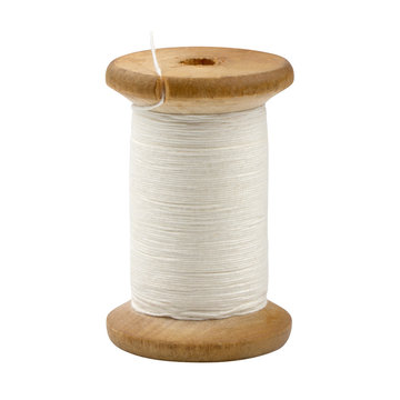 wooden spool of white thread closeup isolated on white background.