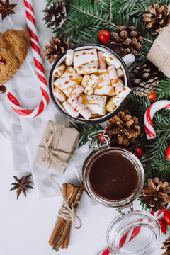 Winter hot drink. Christmas hot chocolate or cocoa with marshmallow, cookies   on white background with christmas decorations. Flat Lay.