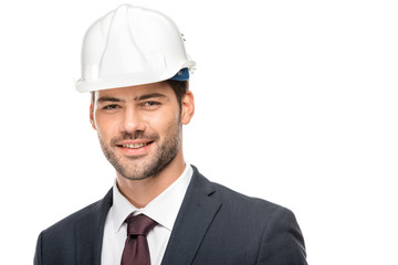 portrait of young male architect in hard hat looking at camera isolated on white