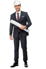 cheerful young male architect in hard hat and jacket holding blueprints isolated on white