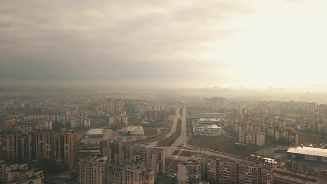 Flying over a concrete living apartment area in east Europa with many birds flying around the drone