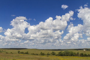 cumulus clouds in blue sky over the Flint Hills, Tallgrass Prairie National Preserve, Kansas