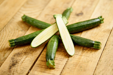 delicious and fresh baby zucchini on an old wooden kitchen table