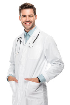 Smiling Young Male Doctor With Stethoscope Over Neck In Medical Coat Isolated On White