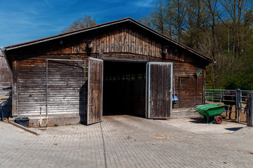 Fototapeta na wymiar Wooden German stable on a horse farm
