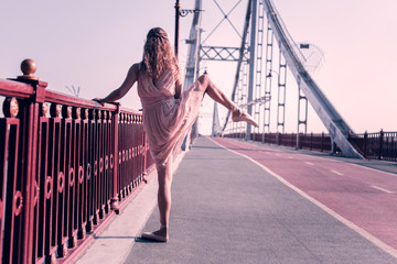 Professional training. Professional nice woman lifting her leg up while holding the bridge © Viacheslav Yakobchuk