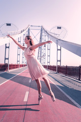 Talented dancer. Nice young woman standing in the dancing position while being on the bridge © Viacheslav Yakobchuk