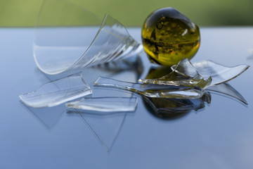 broken glasses containing danger on blue background
