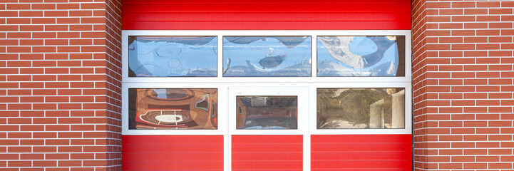 Panoramic photo of the red entrance gate from the fire station