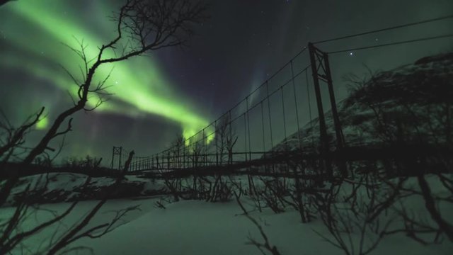 Northern lights over bridge northern Sweden with snow