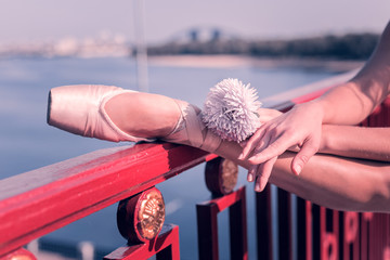 Natural beauty. Close up of a beautiful white flower being in ballerinas hand © Viacheslav Yakobchuk
