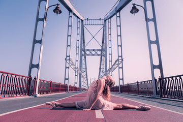 Young talent. Beautiful skilled dancer doing the splits while showing her talent © Viacheslav Yakobchuk
