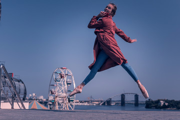 Modern technology. Delighted nice woman jumping while holding her smartphone © Viacheslav Yakobchuk