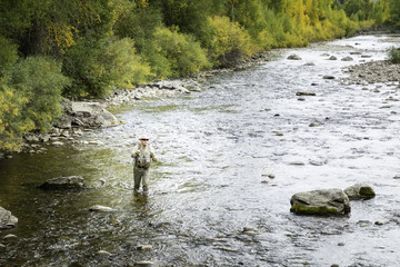 Fly Fisher man in the Rockies