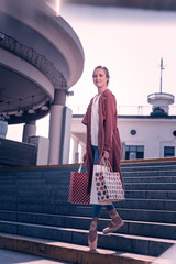 Favourite activity. Delighted professional ballerina standing with shopping bags while enjoying doing shopping © Viacheslav Yakobchuk