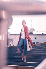 Shopping lover. Nice young ballerina standing with shopping bags while being on the stairs © Viacheslav Yakobchuk