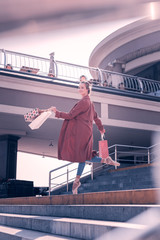 New purchases. Positive attractive dancer standing with her shopping bags after doing the shopping © Viacheslav Yakobchuk
